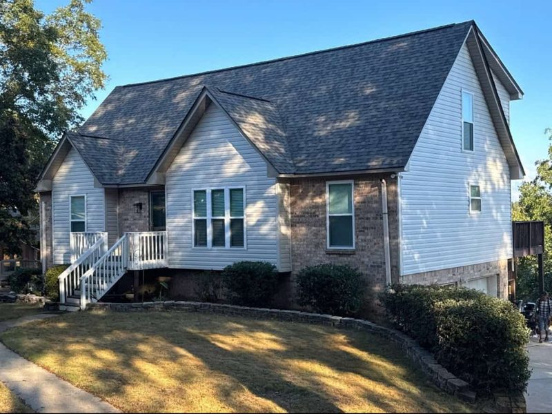 Residential home with a newly installed shingle roof and white siding